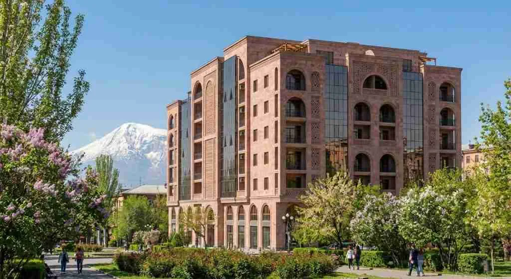 Modern apartment building in Yerevan, Armenia, surrounded by trees.