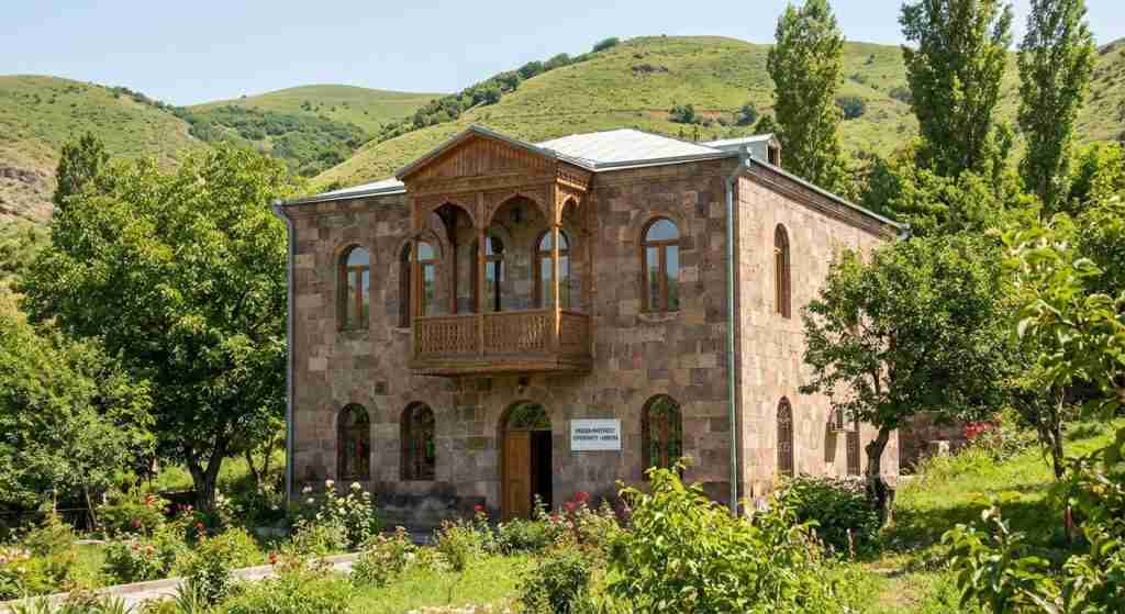 Traditional Armenian architecture set amidst green foliage, representing real estate opportunities.